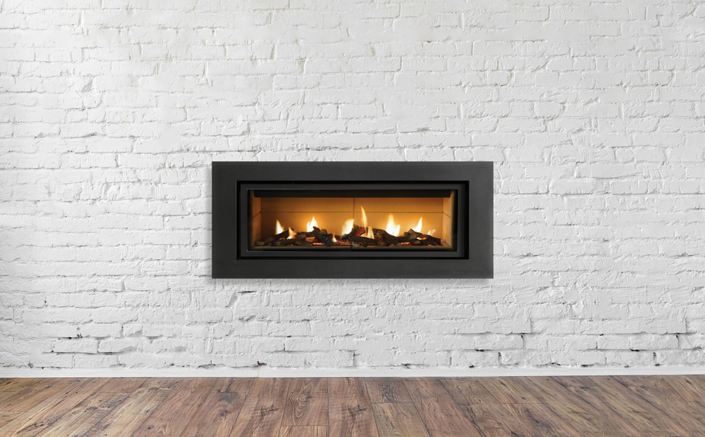 gas fireplace installed in white brick wall