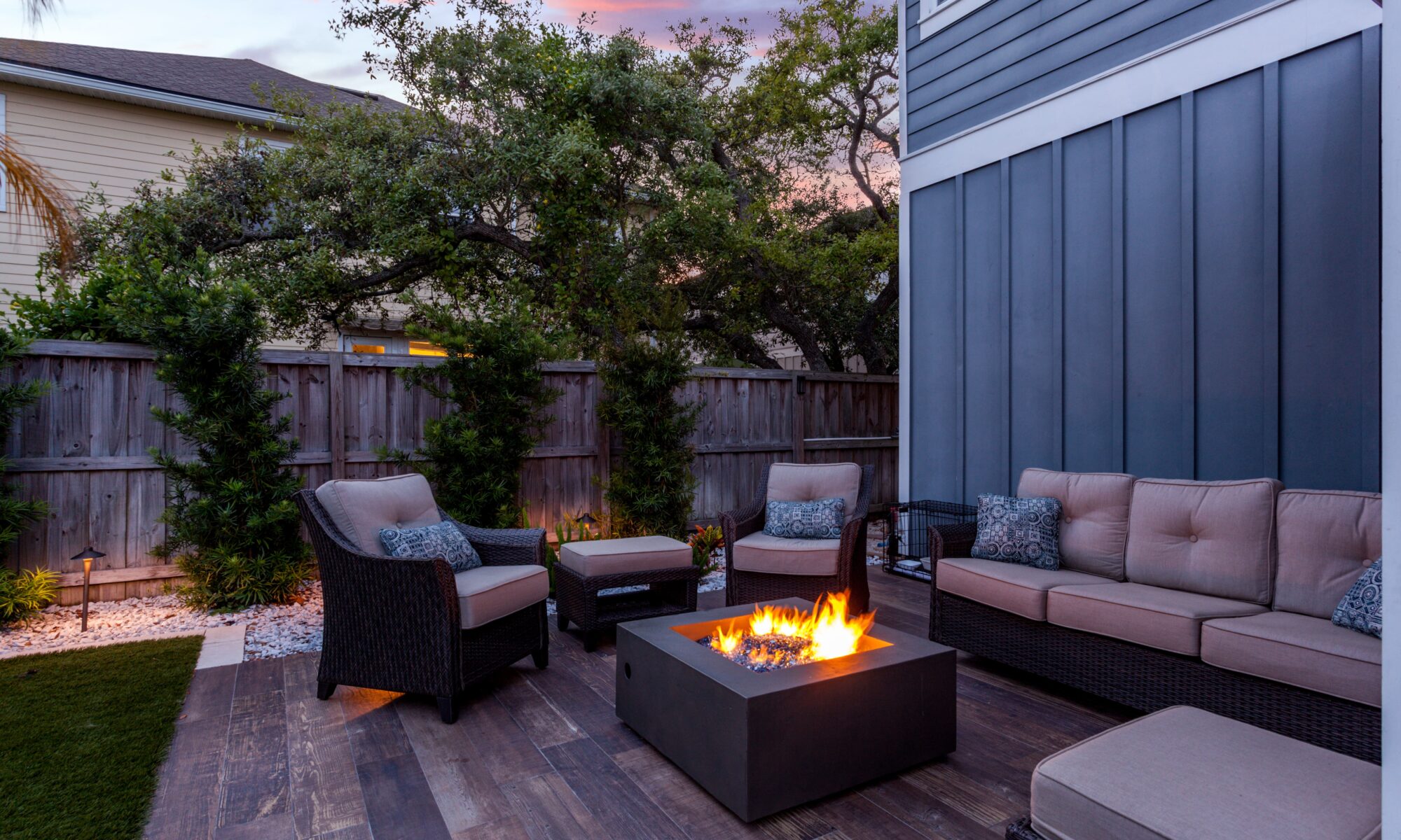 outdoor natural gas fire pit surrounded by furniture