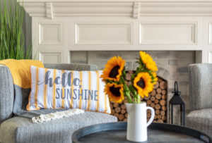 fireplace with sunflowers and a hello sunshine pillow for summer decor as a year round mantle fireplace appliance