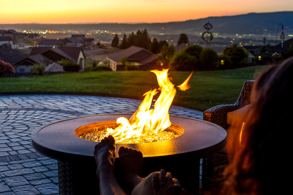 fire pit in a backyard being maintained with fire safety tips and tools