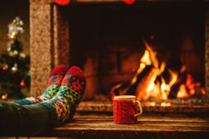 fuzzy socks in living room with fireplace on heating entire home with wood or gas fuel source for efficiency and insulation